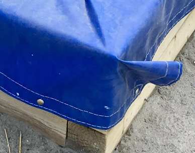 Flat tarp with corner folded Flat tarp with corner folded