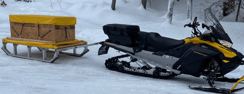 Snowmobile pulling a fishing gear trailer Snowmobile pulling a fishing gear trailer