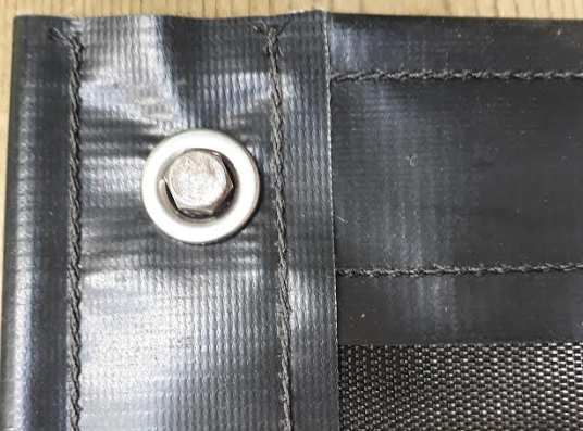 Securing the tarp with an anchor bolt Securing the tarp with an anchor bolt